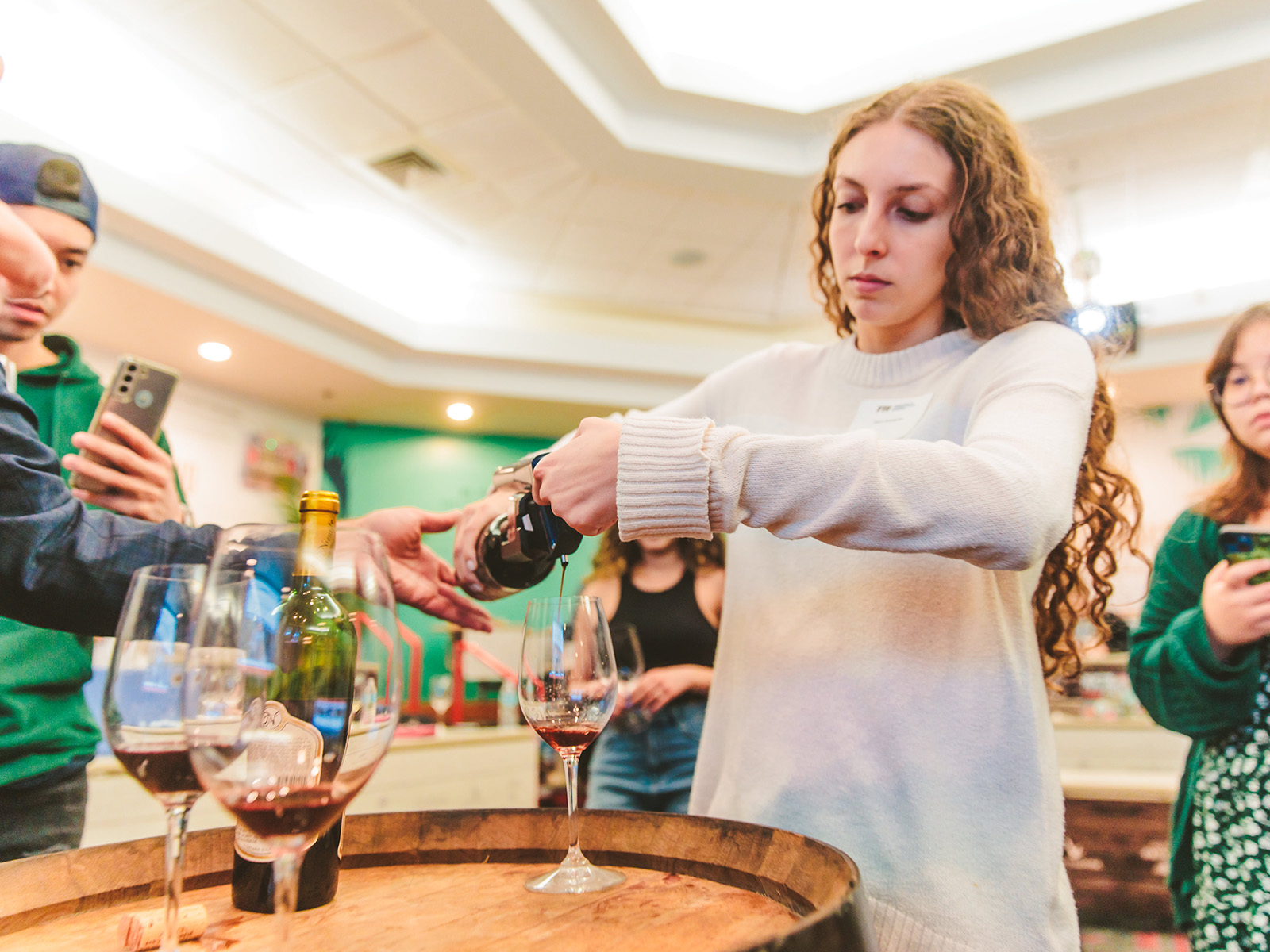 A College of Hospitality student pouring wine