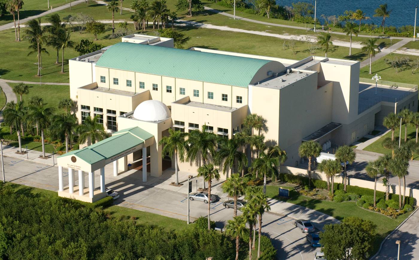 Aerial view of the Kovens Conference Center and its green barrel roof, with Biscayne Bay behind it.
