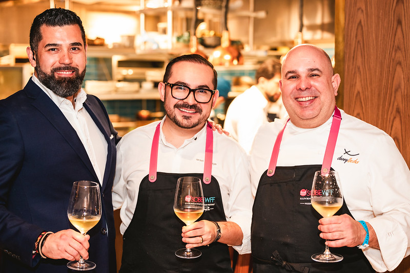 Event attendees showing the paw sign