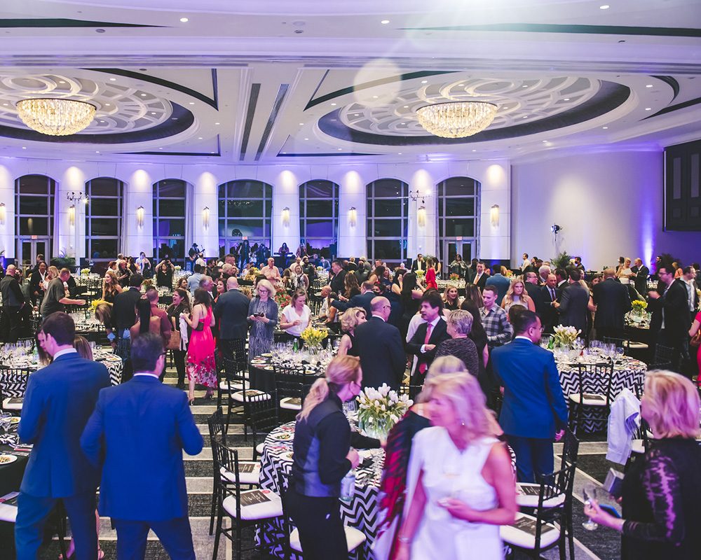 Dinner event space with many guests socializing